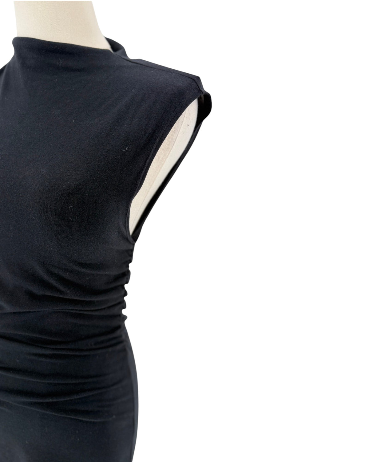 A close-up of a black sleeveless mock-neck dress or bodysuit displayed on a mannequin torso against a plain white background.