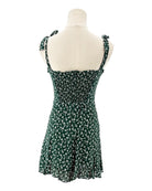 Green floral dress on a mannequin against a white background