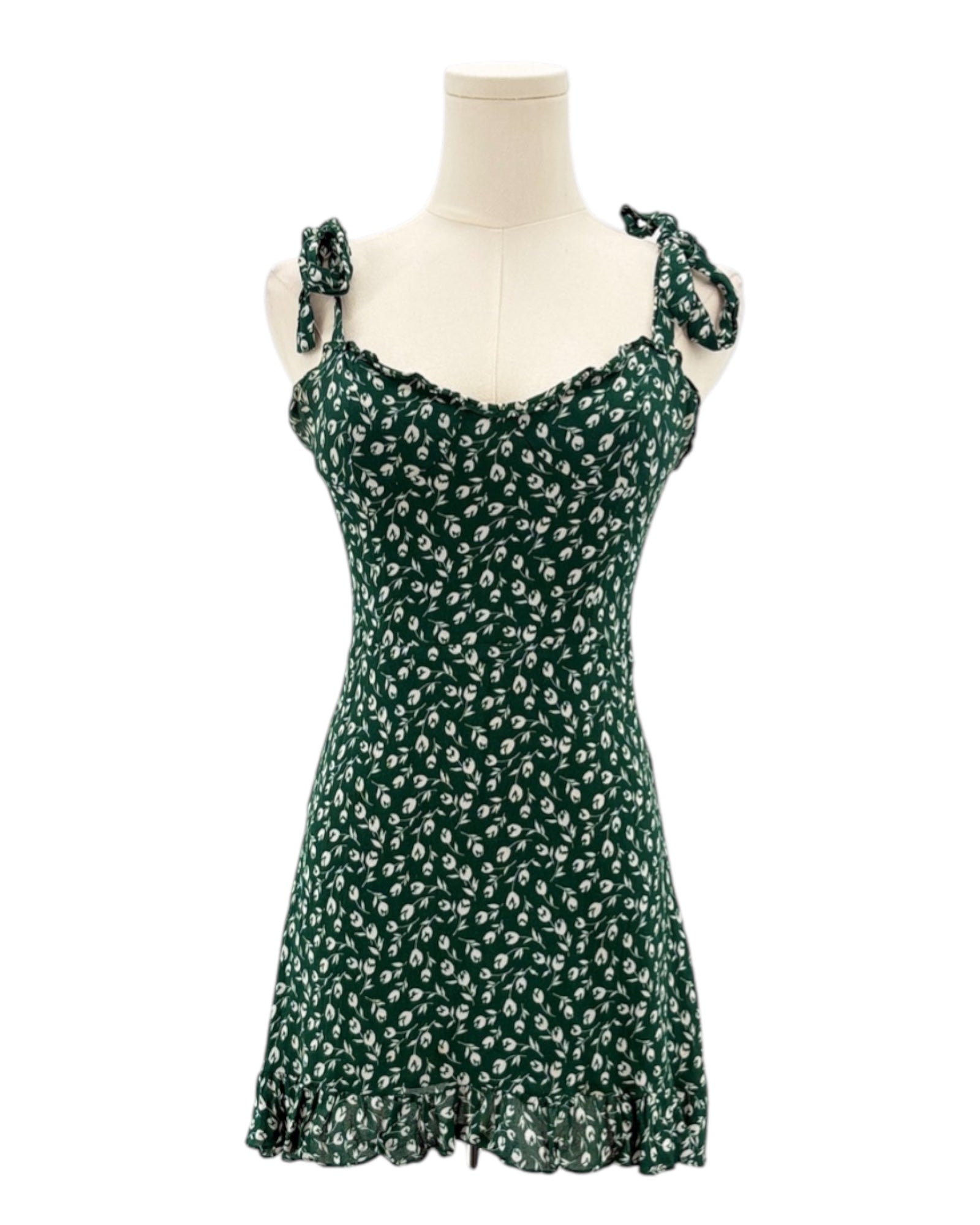 Green floral dress on a mannequin against a white background