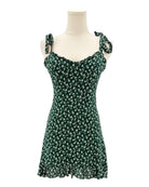 Green floral dress on a mannequin against a white background