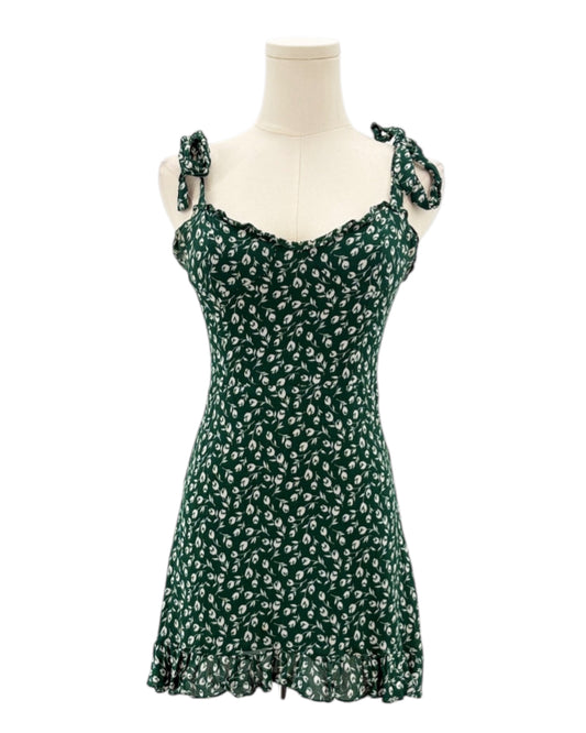 Green floral dress on a mannequin against a white background