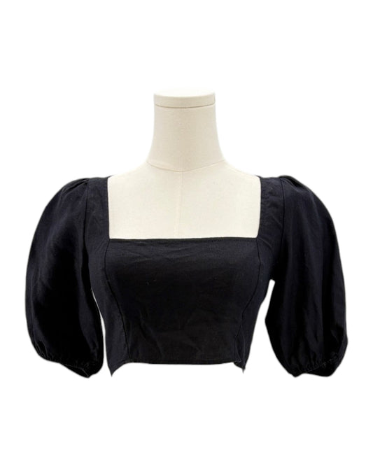 Reformation black blouse with puffed sleeves on a mannequin against a white background