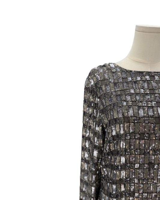 Silver patterned dress on a mannequin against a white background