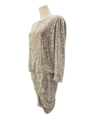 Gold sequin dress on a mannequin against a white background