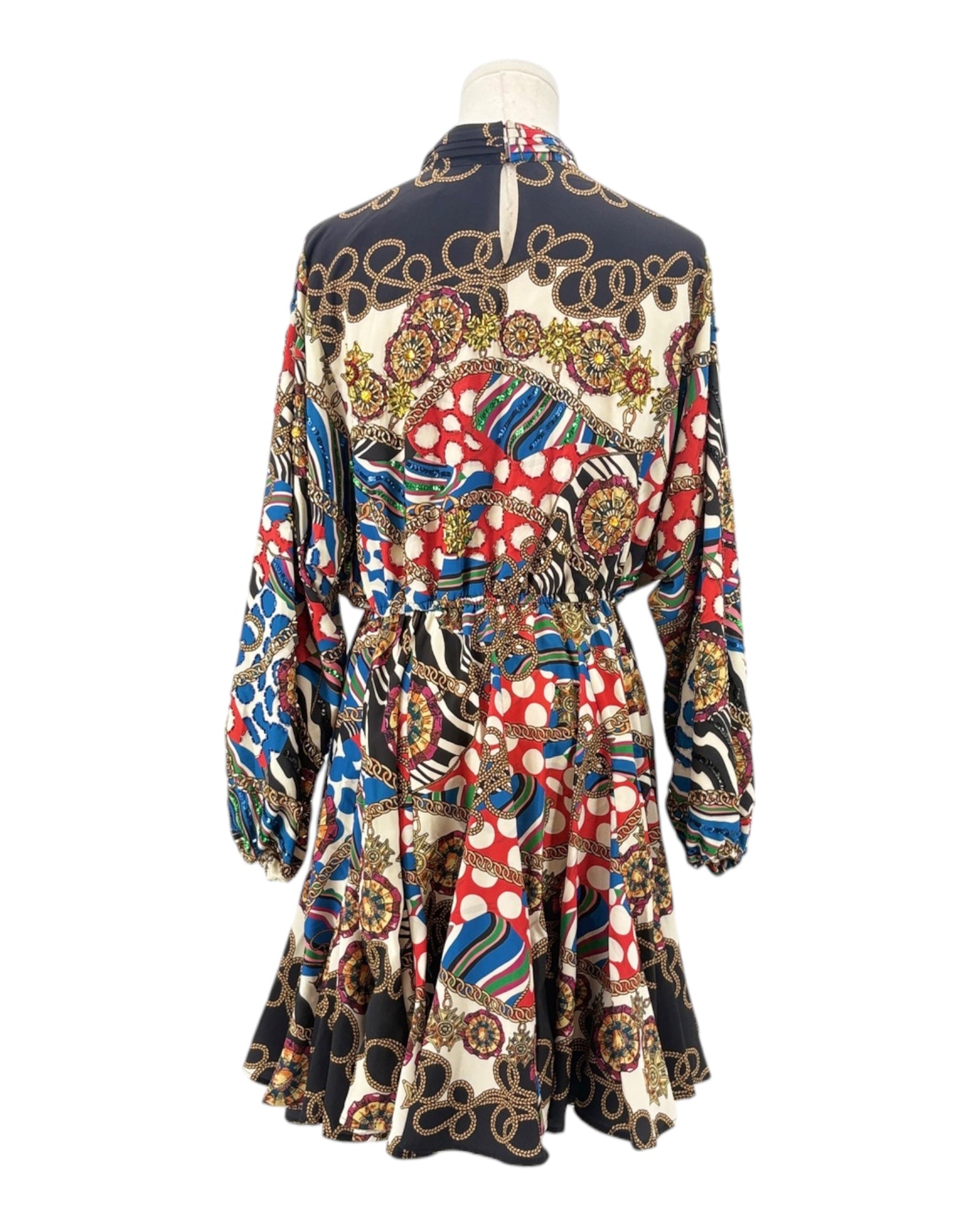 Colorful patterned dress on a mannequin against a white background