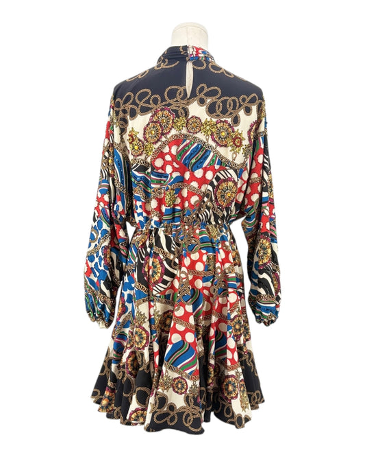 Colorful patterned dress on a mannequin against a white background