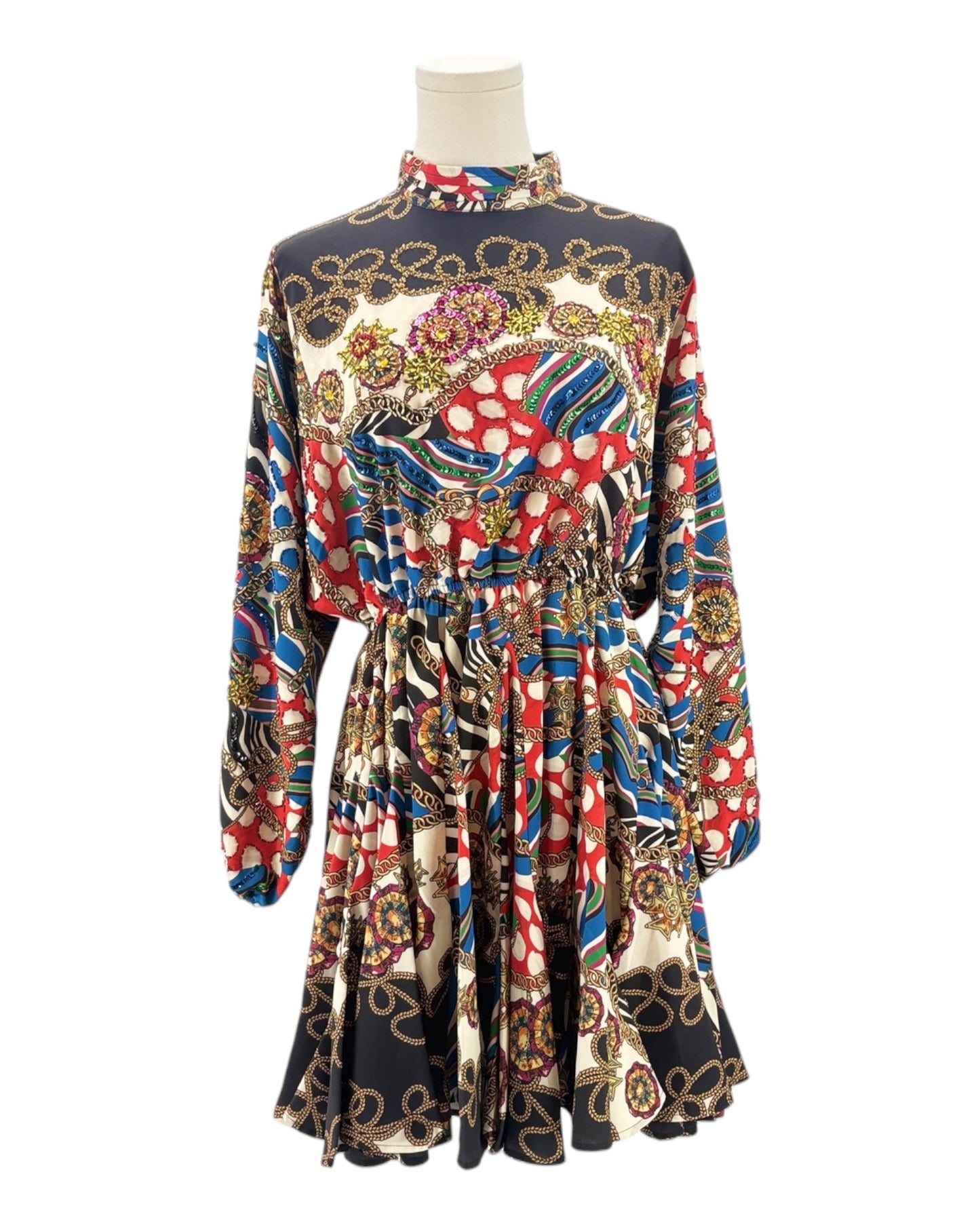 Colorful patterned dress on a mannequin against a white background