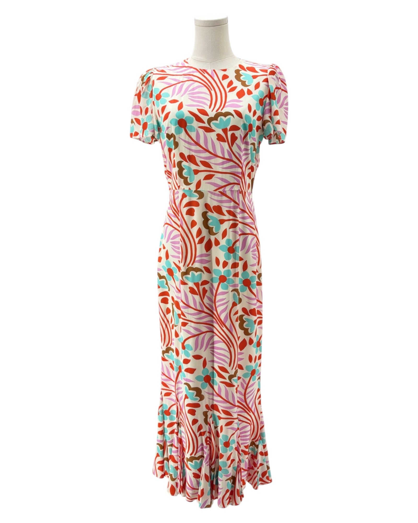 Colorful patterned dress on a mannequin against a white background