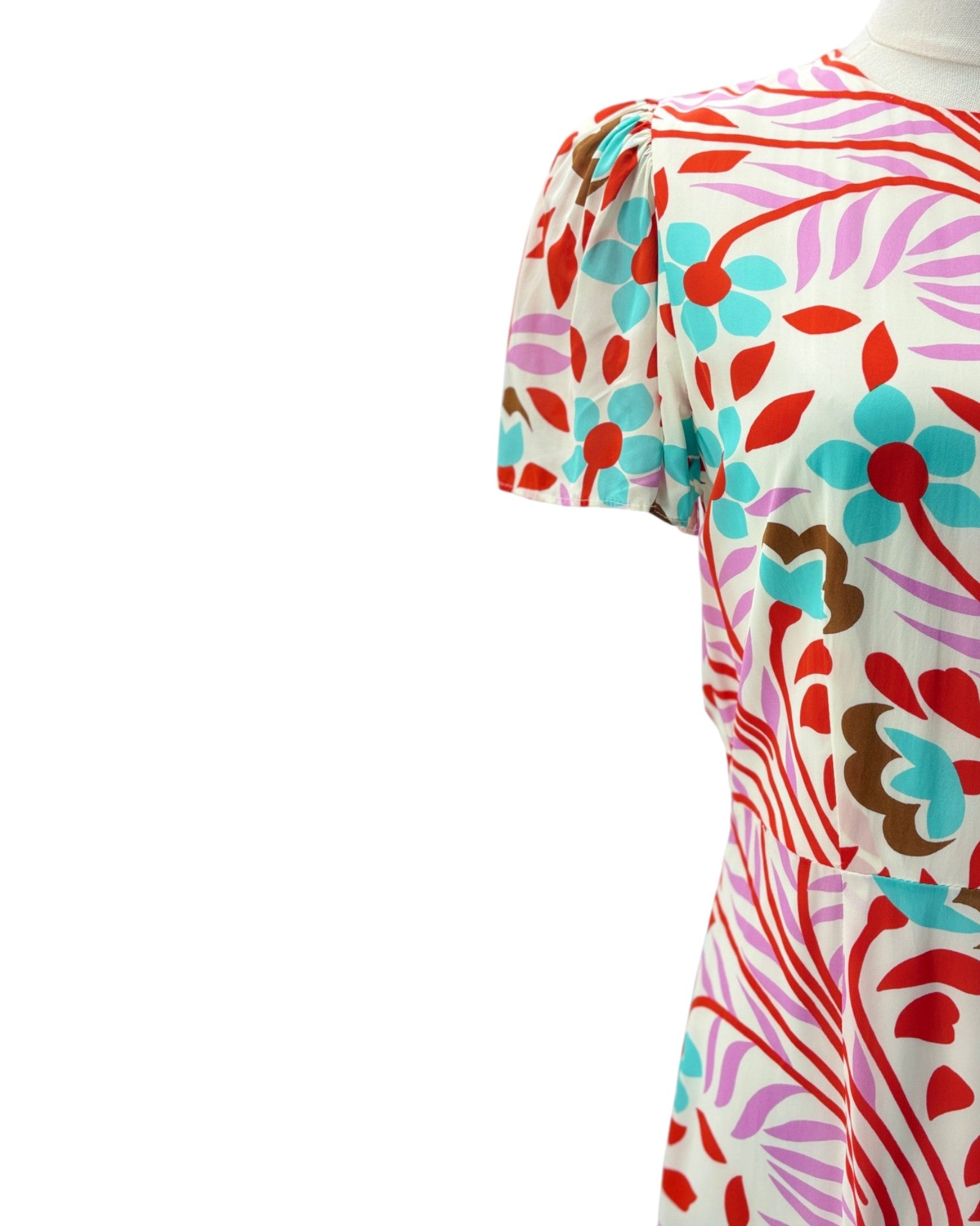 Colorful floral and abstract patterned dress on a white background