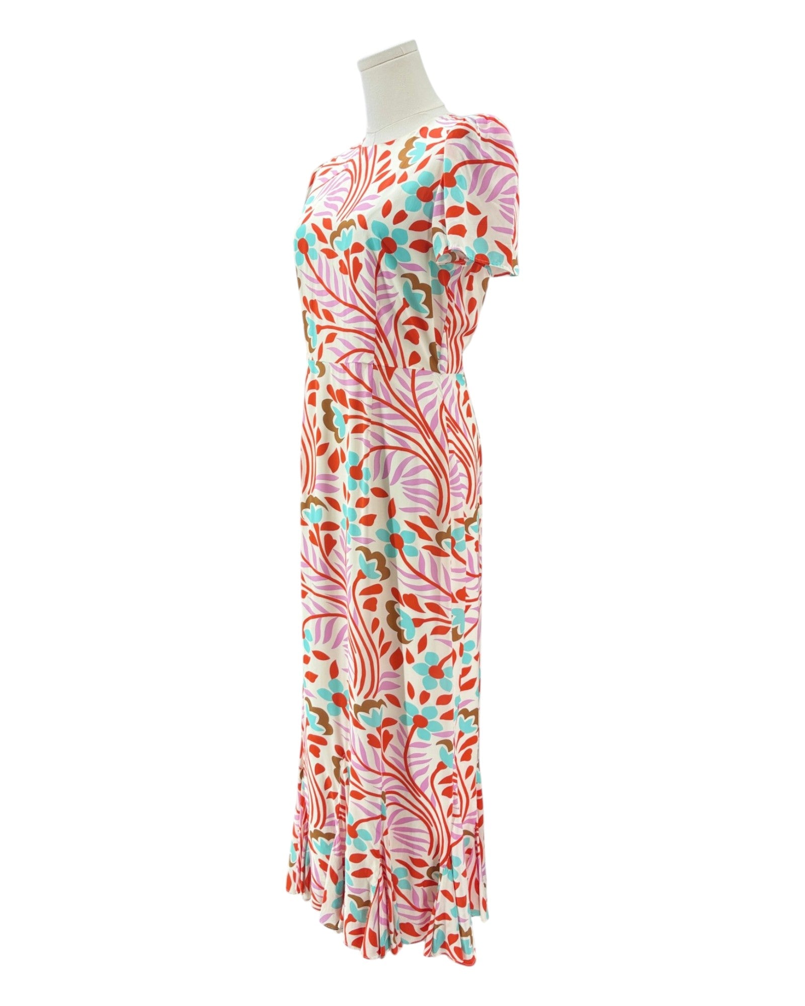 Colorful floral-patterned dress on a mannequin against a white background