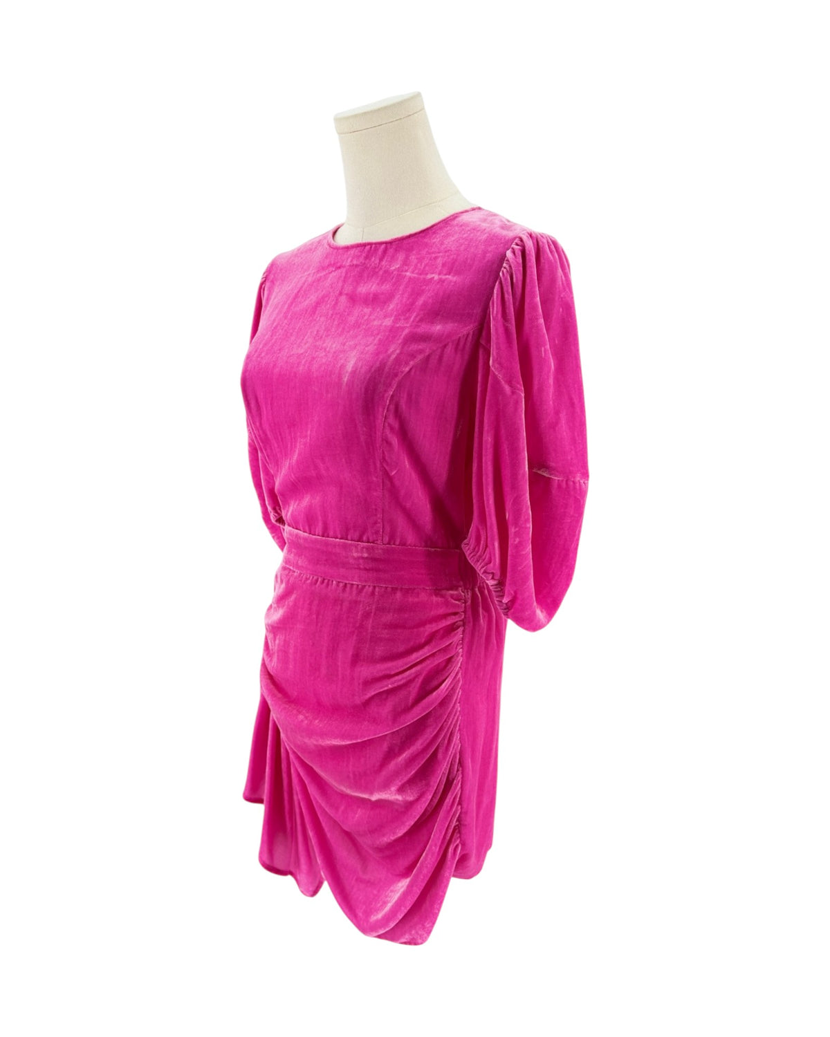 A bright magenta pink velvet dress on a mannequin, showing the back of the neck, three-quarter puffed sleeves, and a matching fabric belt at the waist against a plain white background.