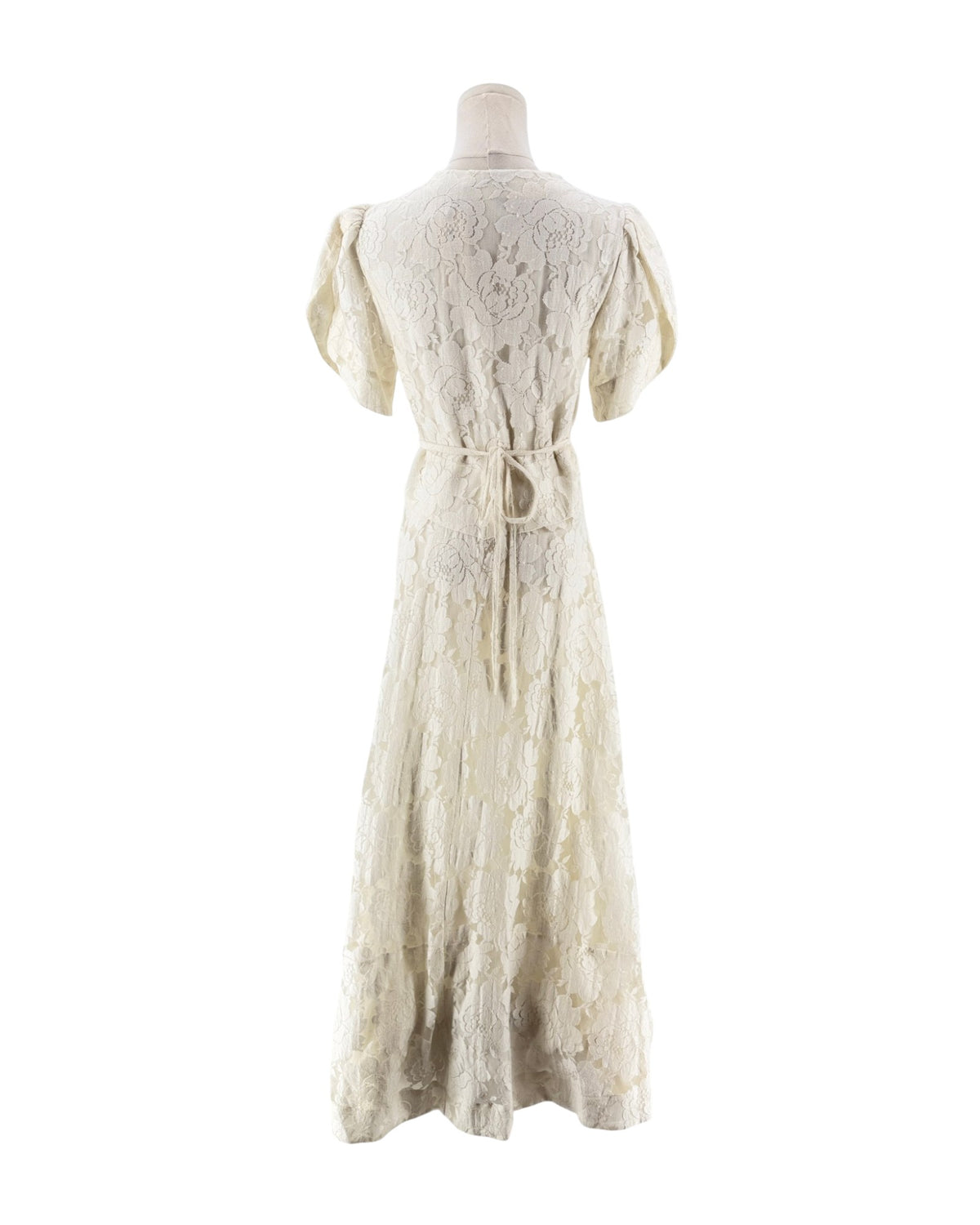 An off-white lace maxi dress with short puff sleeves, a deep V-neckline, and a lace-up front bodice, displayed on a mannequin against a white background.