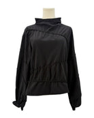 Rohe black long-sleeve shirt on a mannequin against a white background