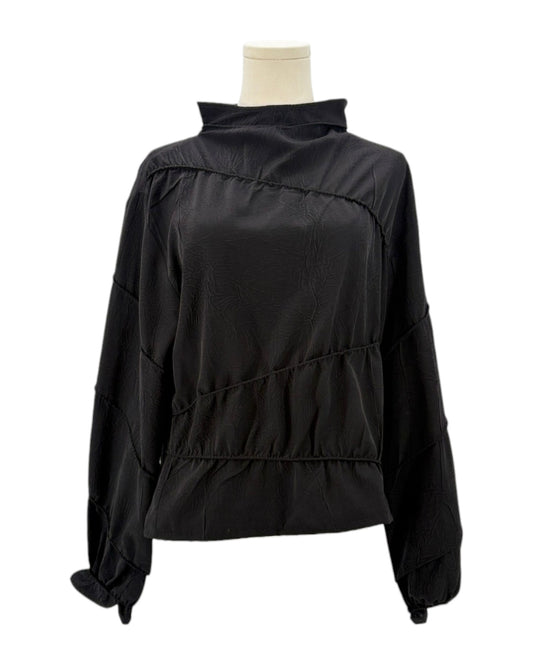 Rohe black long-sleeve shirt on a mannequin against a white background