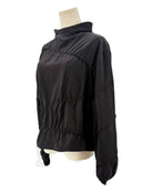 Rohe black long-sleeve shirt on a mannequin against a white background