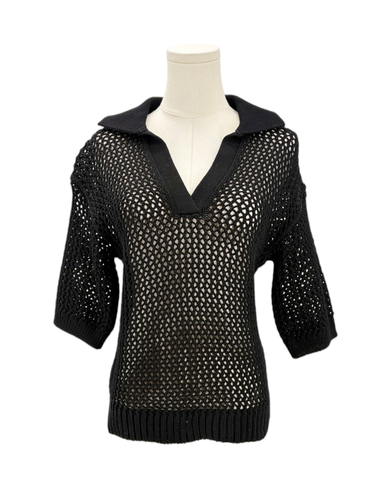 Black knit sweater on a mannequin against a white background