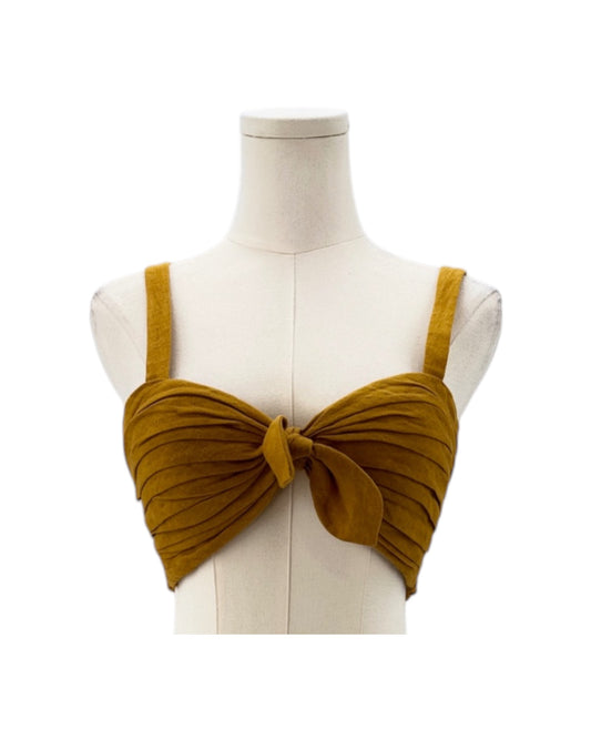 Mustard yellow bikini top on a mannequin against a white background