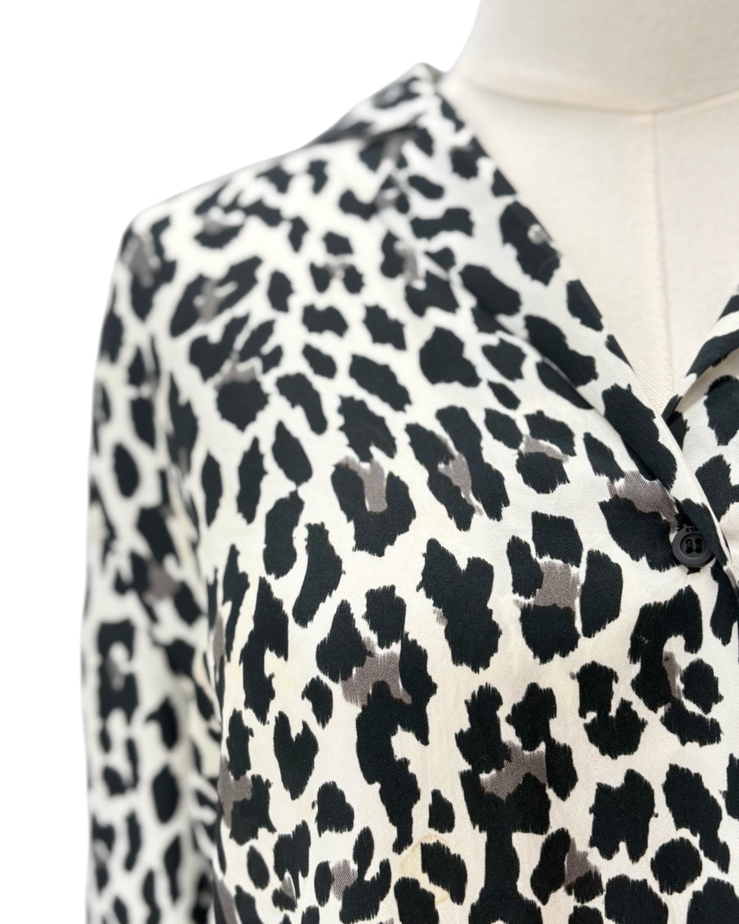 Leopard print blouse on a mannequin with a white background