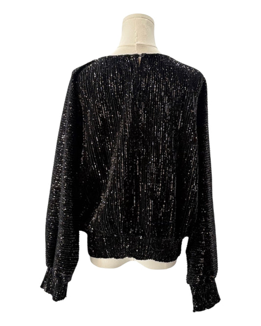 Black sequin blouse on a mannequin against a white background