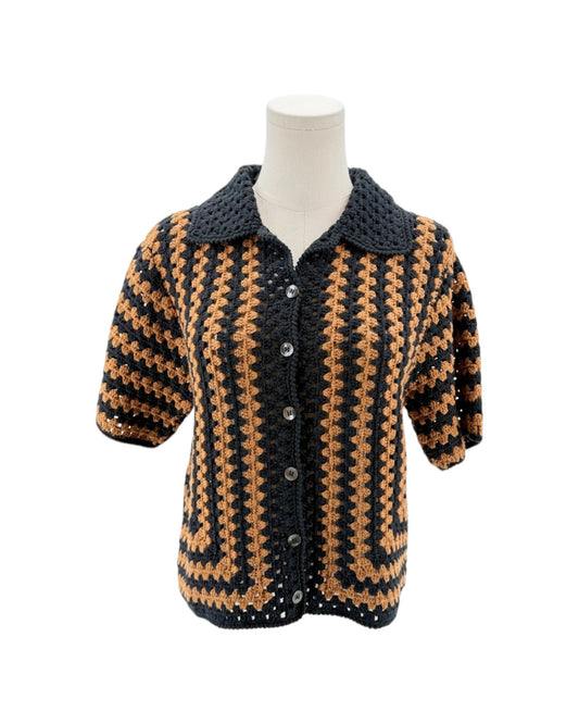 Crocheted black and brown patterned jacket on a mannequin against a white background