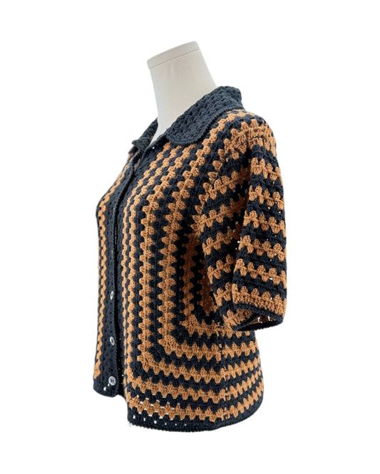 Knitted button front top with black and brown pattern on a mannequin against a white background