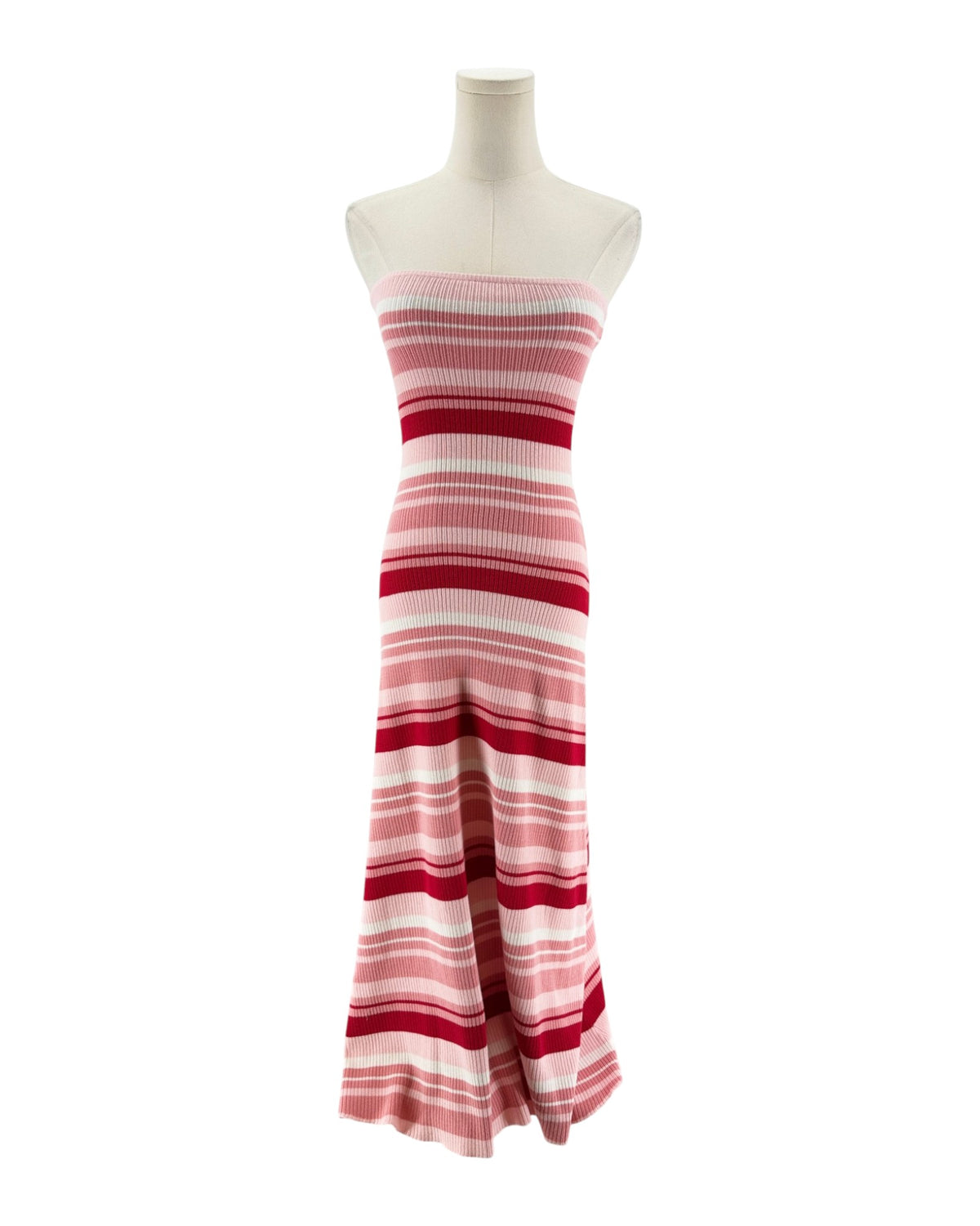 A strapless knit maxi dress with horizontal pink, red, and white stripes, displayed on a cream mannequin torso against a plain white background.