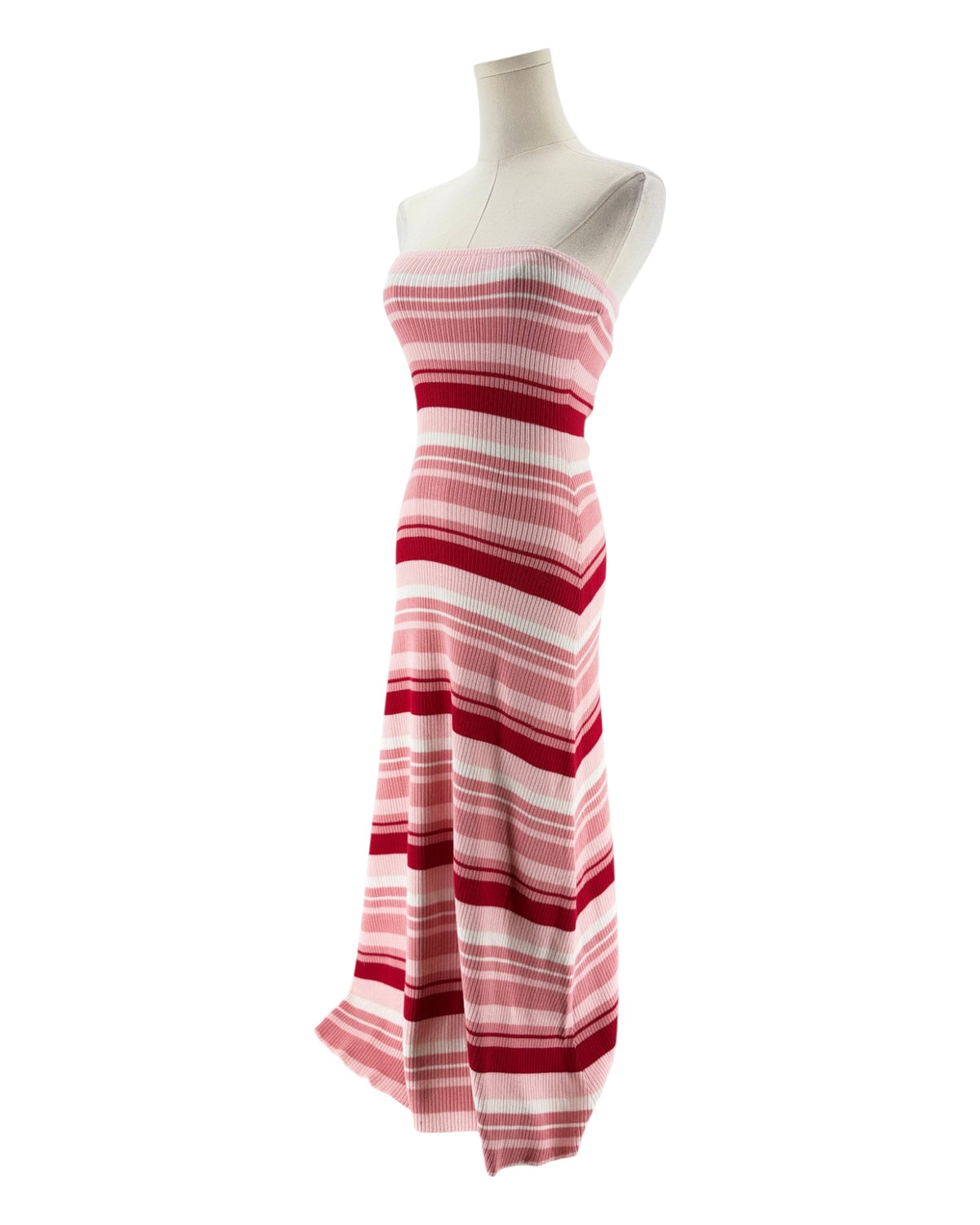 A strapless knit maxi dress with horizontal pink, red, and white stripes, displayed on a white mannequin against a plain white background.