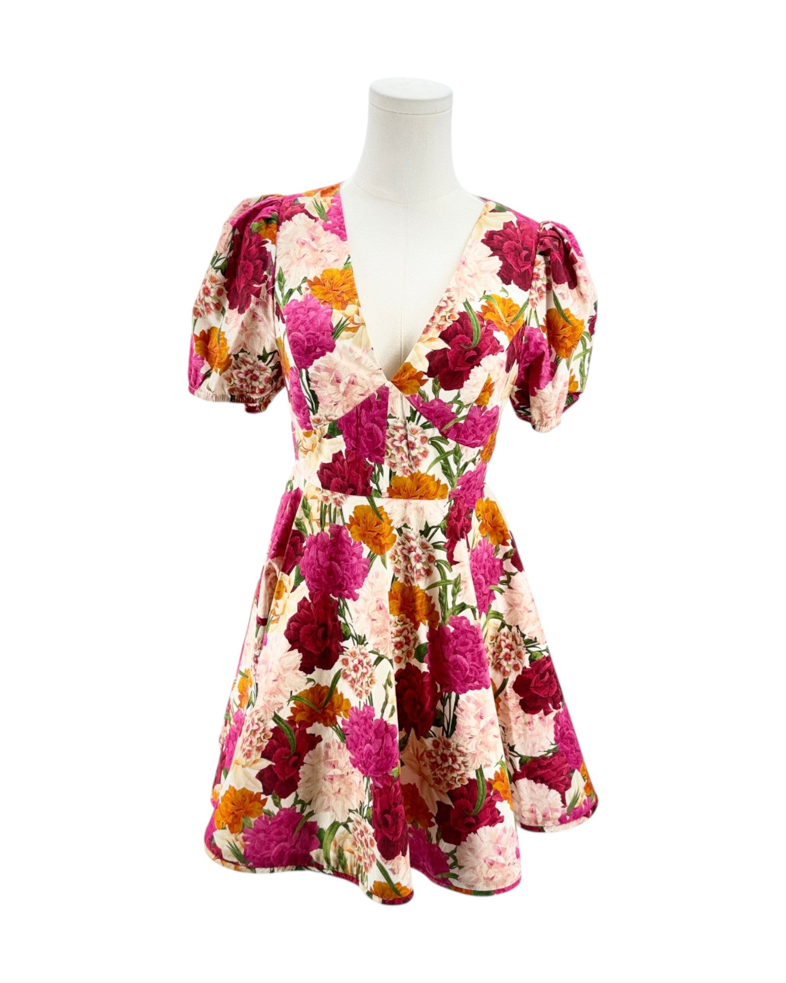 Floral dress on a mannequin against a white background