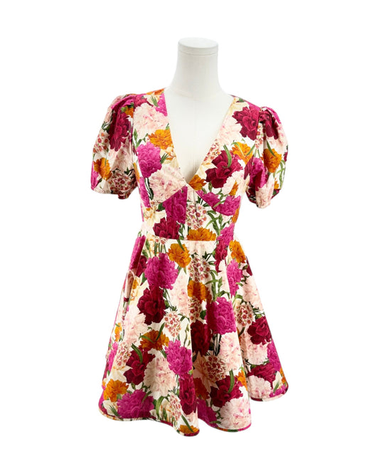 Floral dress on a mannequin against a white background