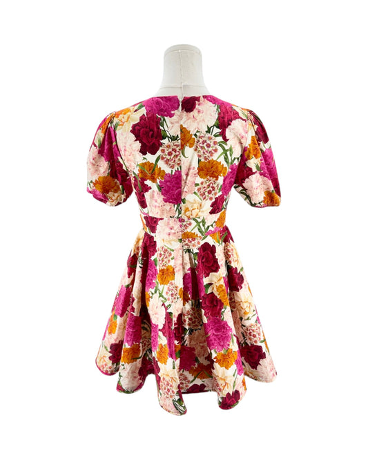Floral dress on a mannequin against a white background