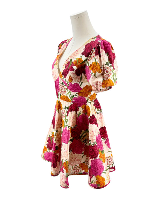 Colorful floral dress on a mannequin against a white background
