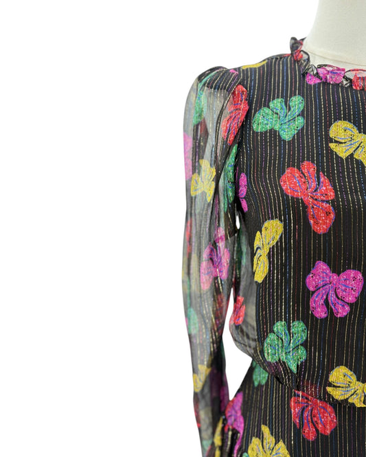 Colorful floral-patterned dress on a mannequin against a white background