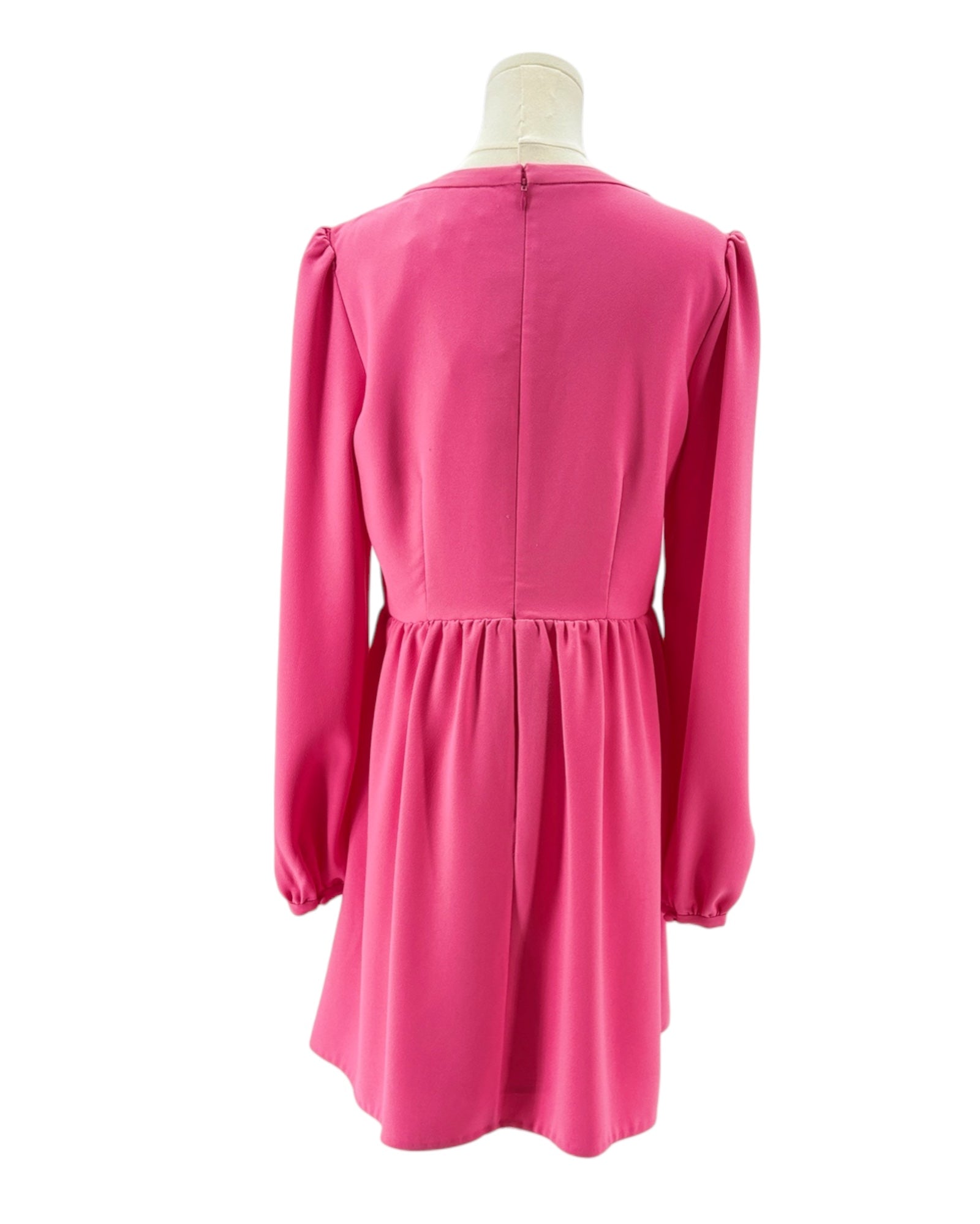 Pink dress on a mannequin against a white background