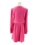 Pink dress on a mannequin against a white background