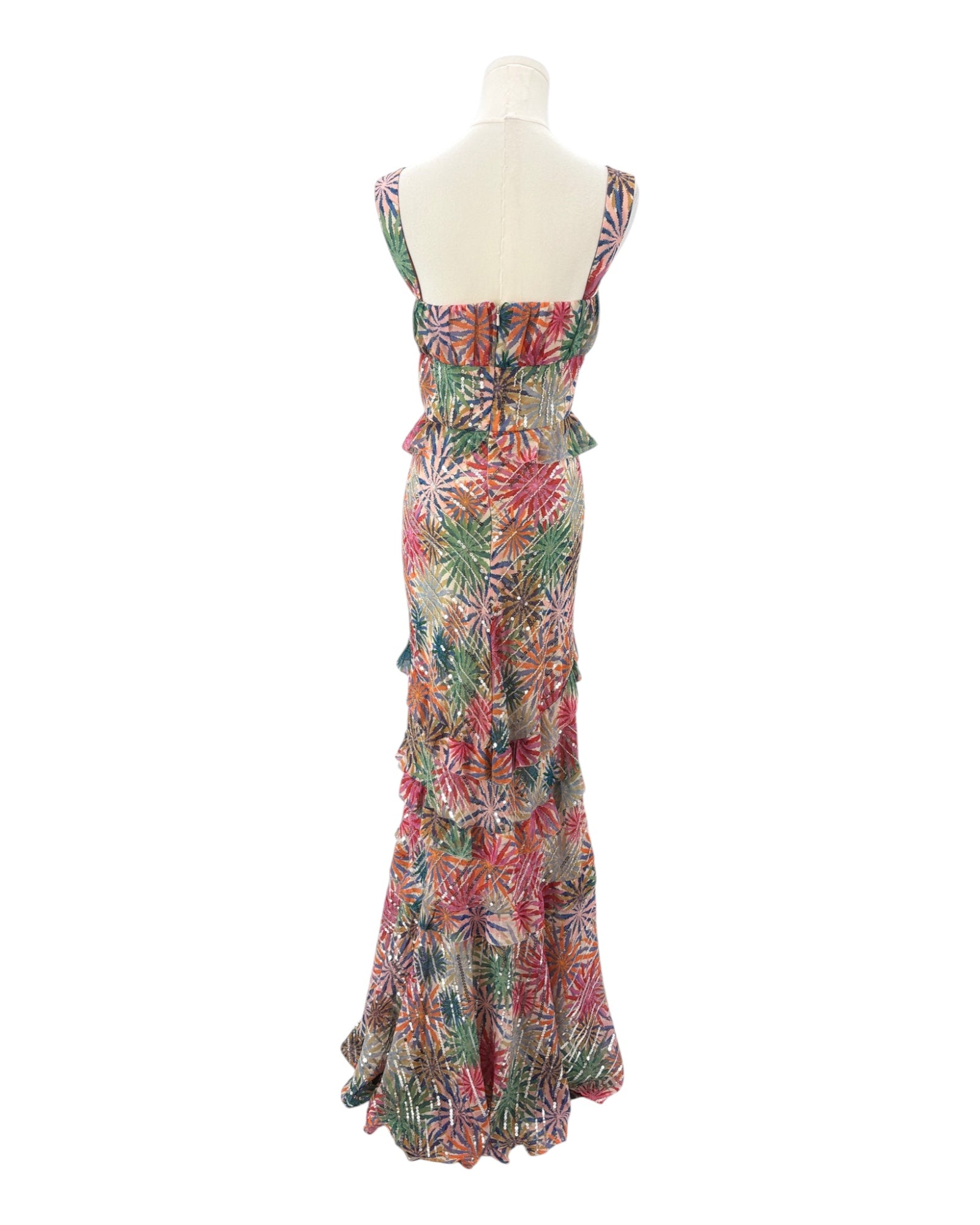 Colorful floral dress on a mannequin against a white background