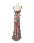 Colorful floral dress on a mannequin against a white background