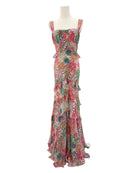 Colorful floral dress on a mannequin against a white background