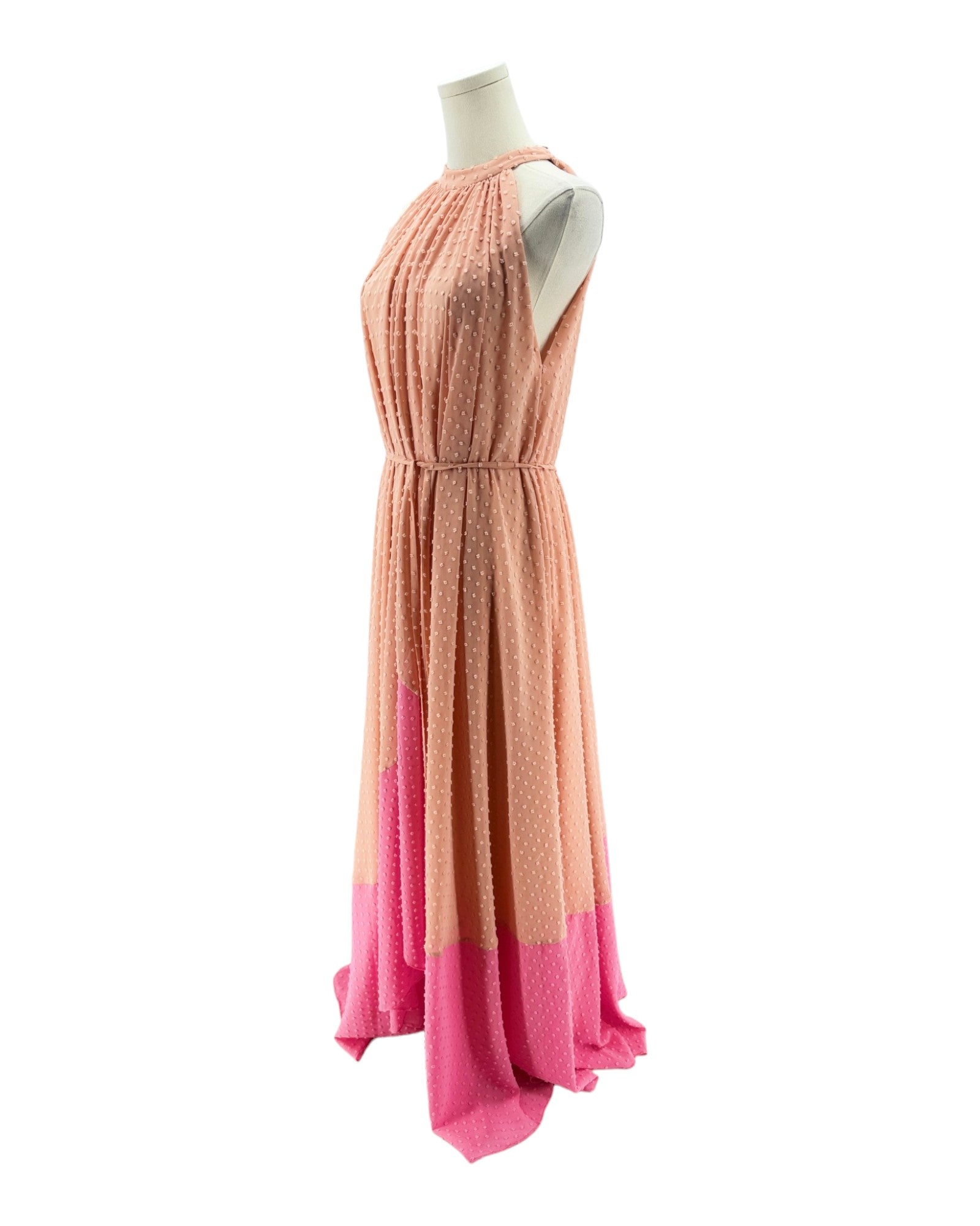 Mannequin wearing a dress with a gradient from pink to peach on a white background