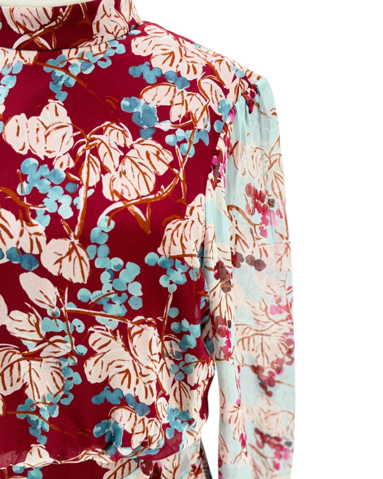 Floral patterned shirt with red, blue, and beige colors on a white background