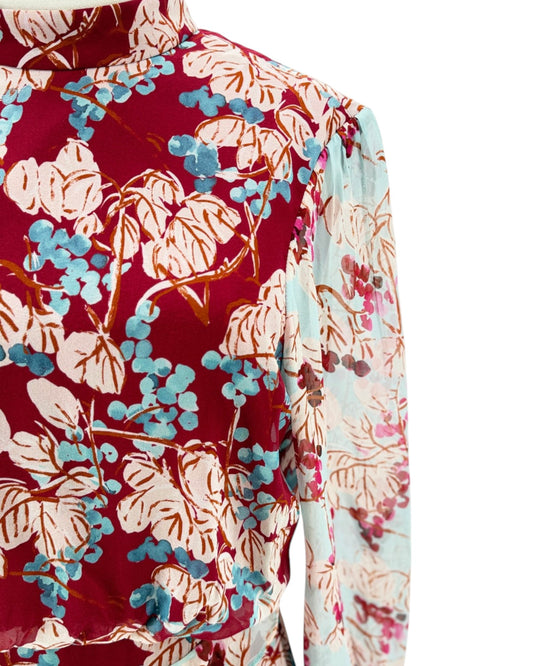 Floral patterned shirt with red, blue, and beige colors on a white background