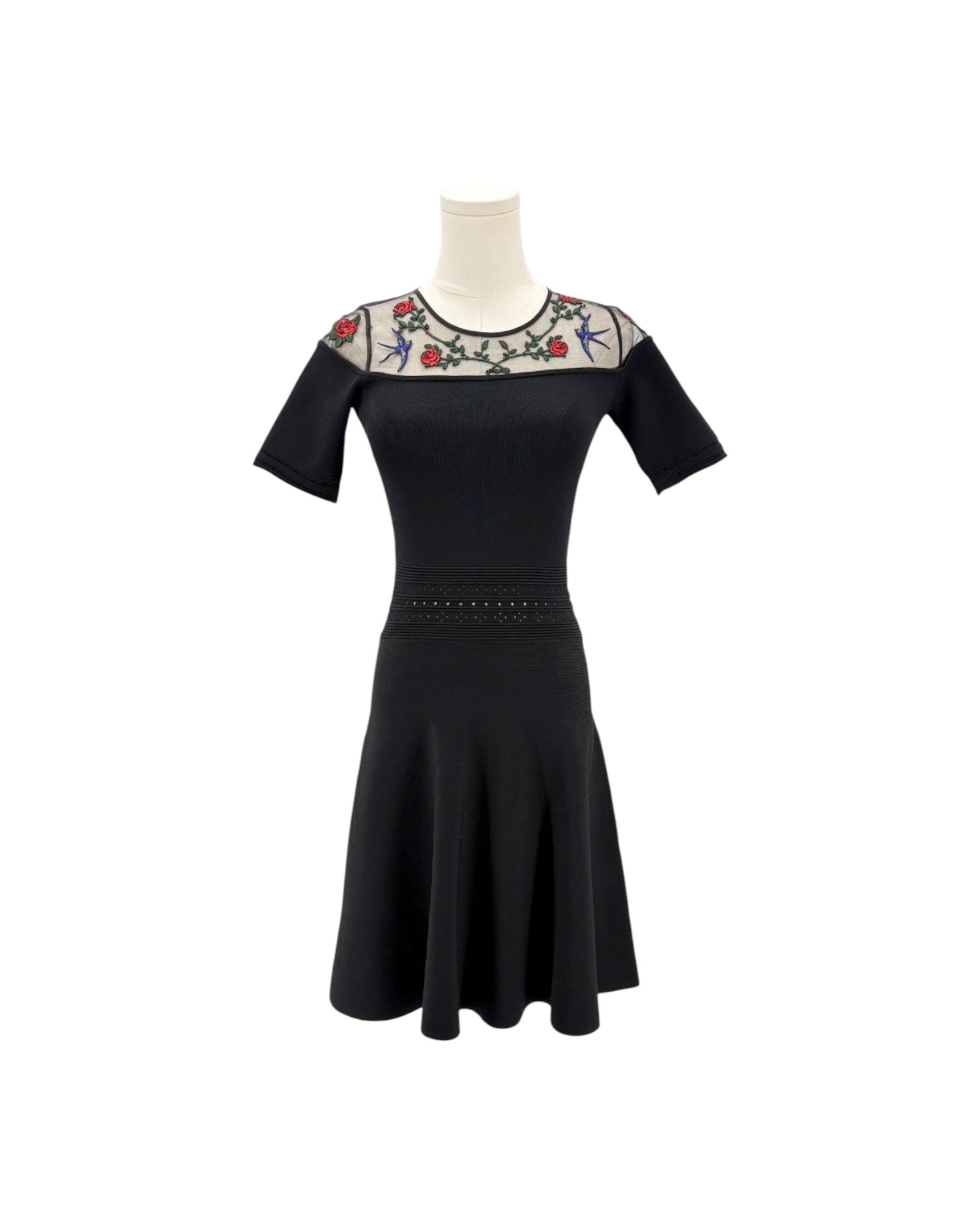 Black dress with floral embroidery on a white background