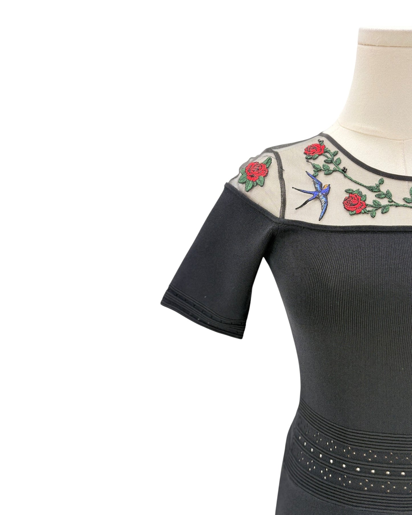Black dress with floral embroidery on a white background