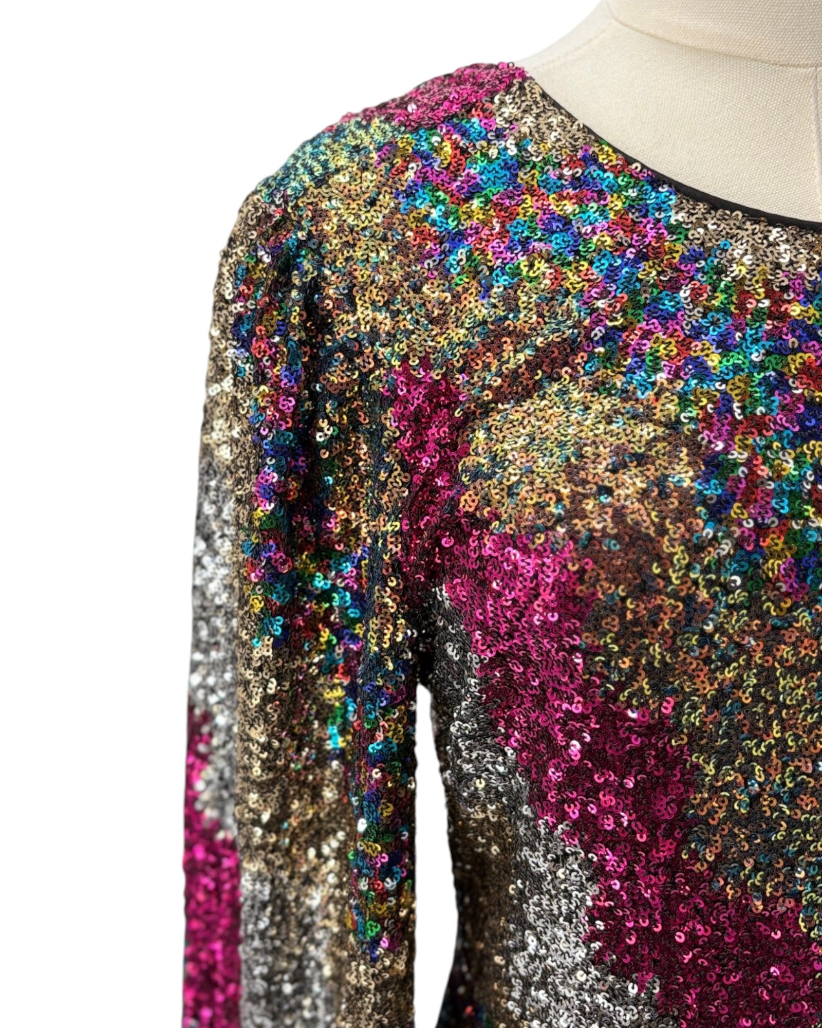Multicolored sequin dress on a mannequin with a white background