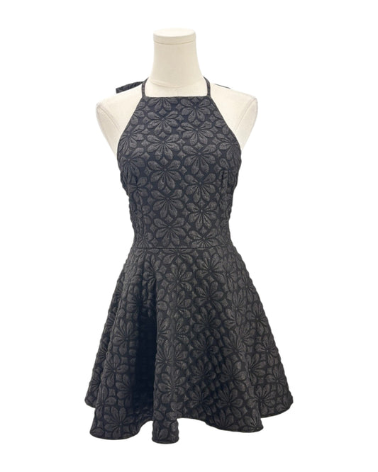 Black dress on a mannequin against a white background