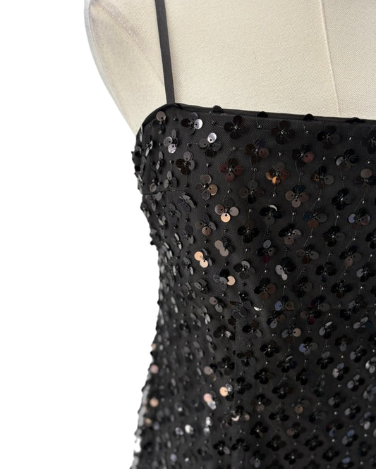Black sequin dress on a mannequin with a white background