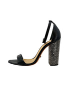 Black sandal with a block heel featuring crystal embellishments on a white background