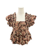 Floral patterned fabric with ruffled details on a white background
