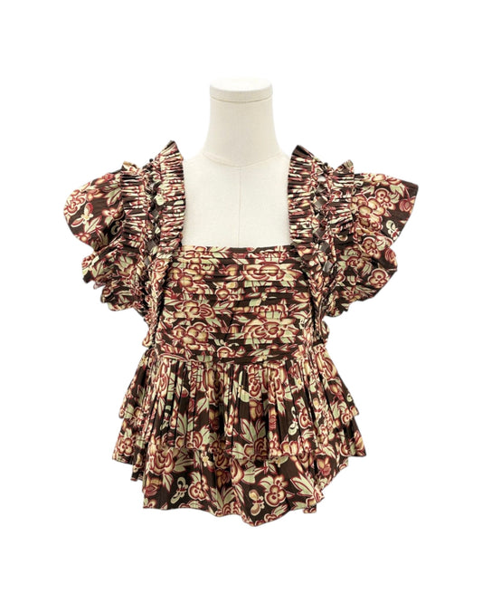 Floral patterned fabric with ruffled details on a white background