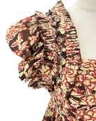Floral patterned fabric with ruffled details on a white background