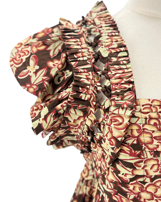 Floral patterned fabric with ruffled details on a white background